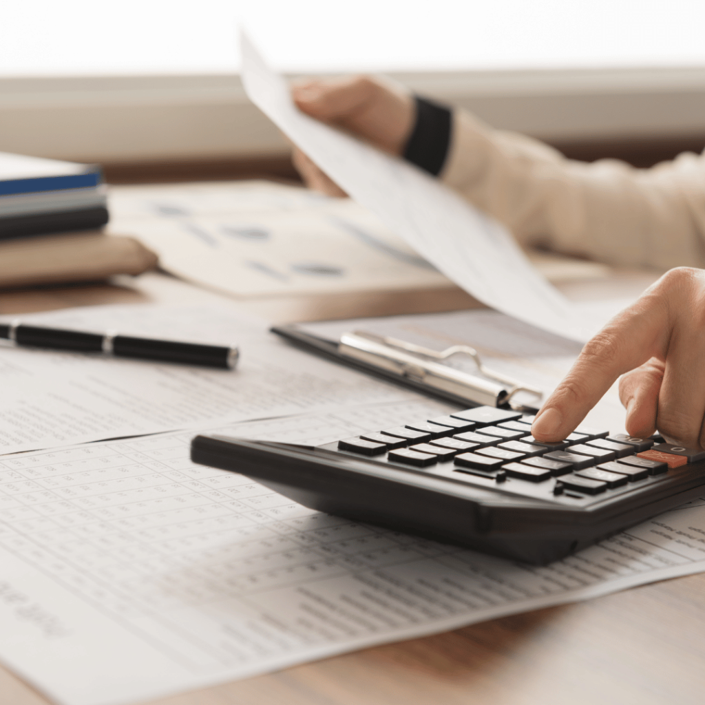 an person holding a paper calculating the business tax