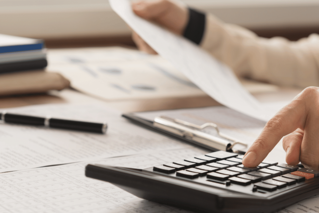 an person holding a paper calculating the business tax